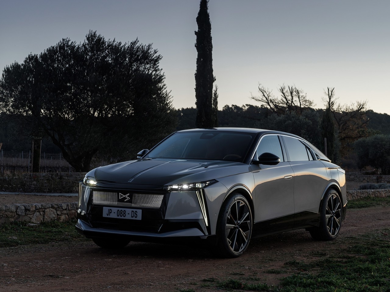 Auto DS grigia con fari accesi di sera